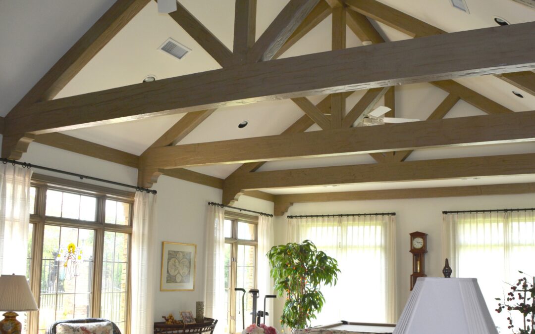 An interior home in Tulsa Ok with a fresh coat of paint that has a high ceiling and wooden beams.