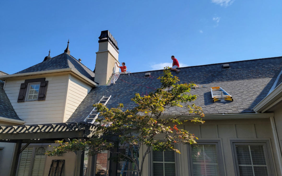 JT Paint & Design crew on top of a roof painting