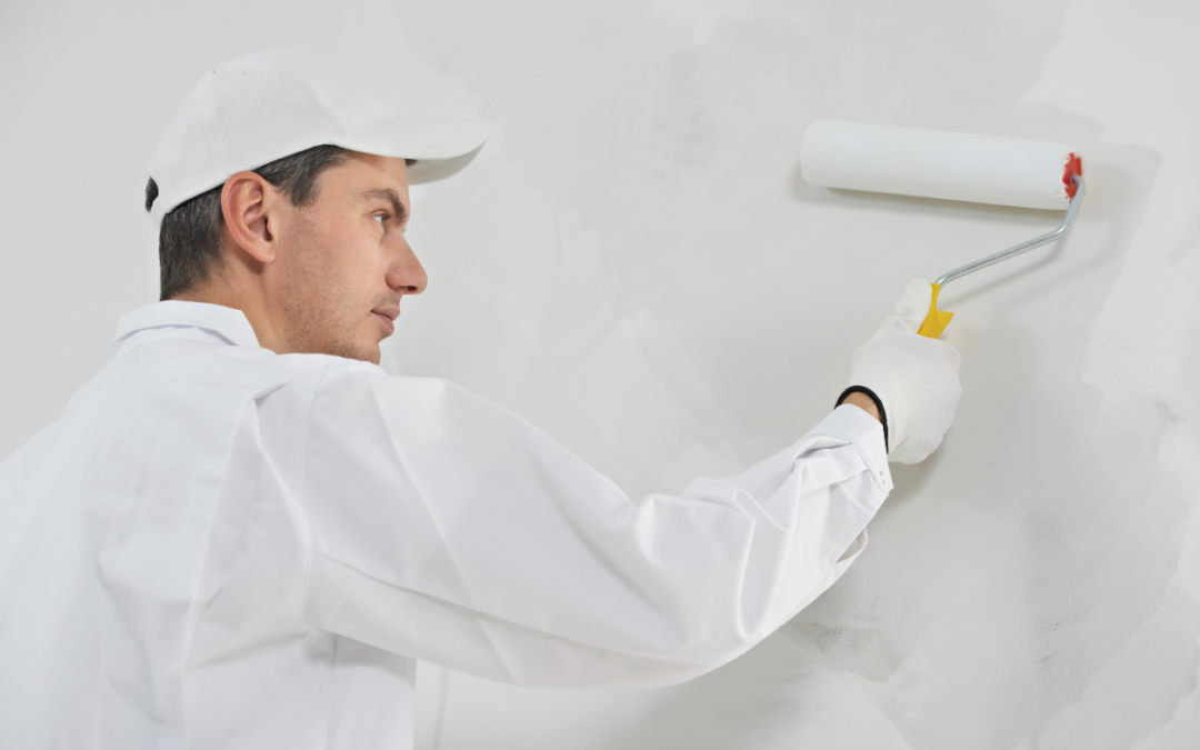 Painter painting a white wall