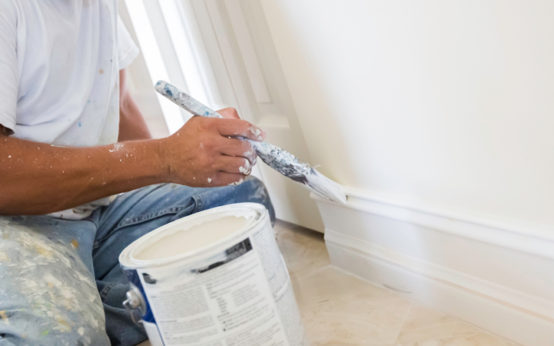Man painting a baseboard