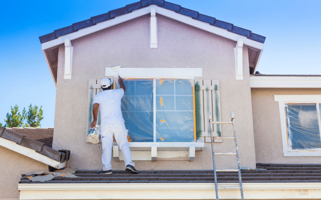 House painter painting an exterior of a House