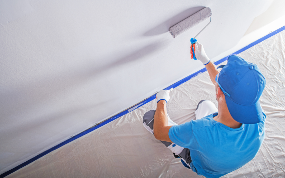 Painter using a roller to paint a wall