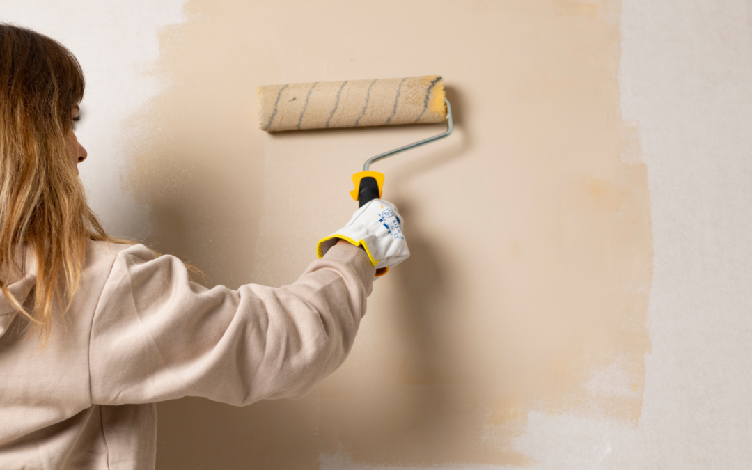 A woman painting a wall