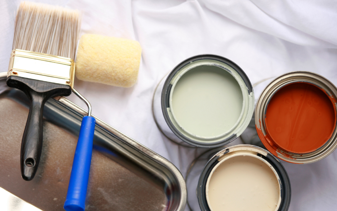 Paint brushes and cans of paint